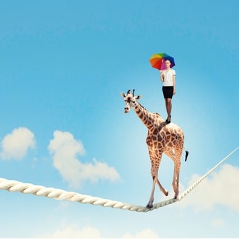 Woman on the back of a giraffe walking on a tightrope, finding balance and courage